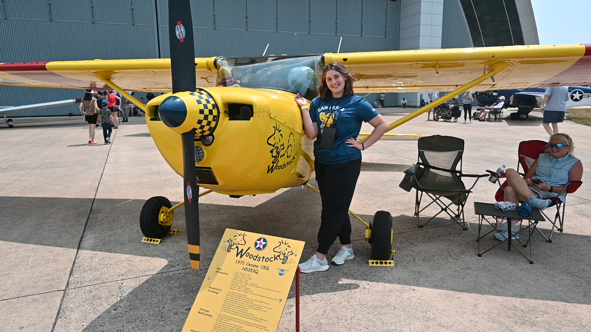 Cameron Gordon standing in front of a yellow airplane